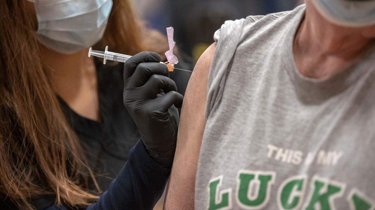 Christine Said administers the COVID-19 vaccine to Robert Moyer, of Lexington, during a Lexington-Fayette County Health Department vaccination clinic at Consolidated Baptist Church in Lexington, Ky., on Wednesday, Feb. 3, 2021.