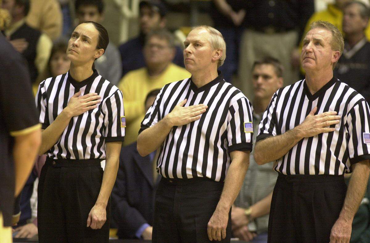 Lisa Mattingly, left, stood at attention during the national anthem before she officiated a game between Purdue and Michigan State at West Lafayette, Ind., in 2003. Before her officiating career, Mattingly played high school basketball at Marion County and college ball at Sue Bennett College and Georgetown College.