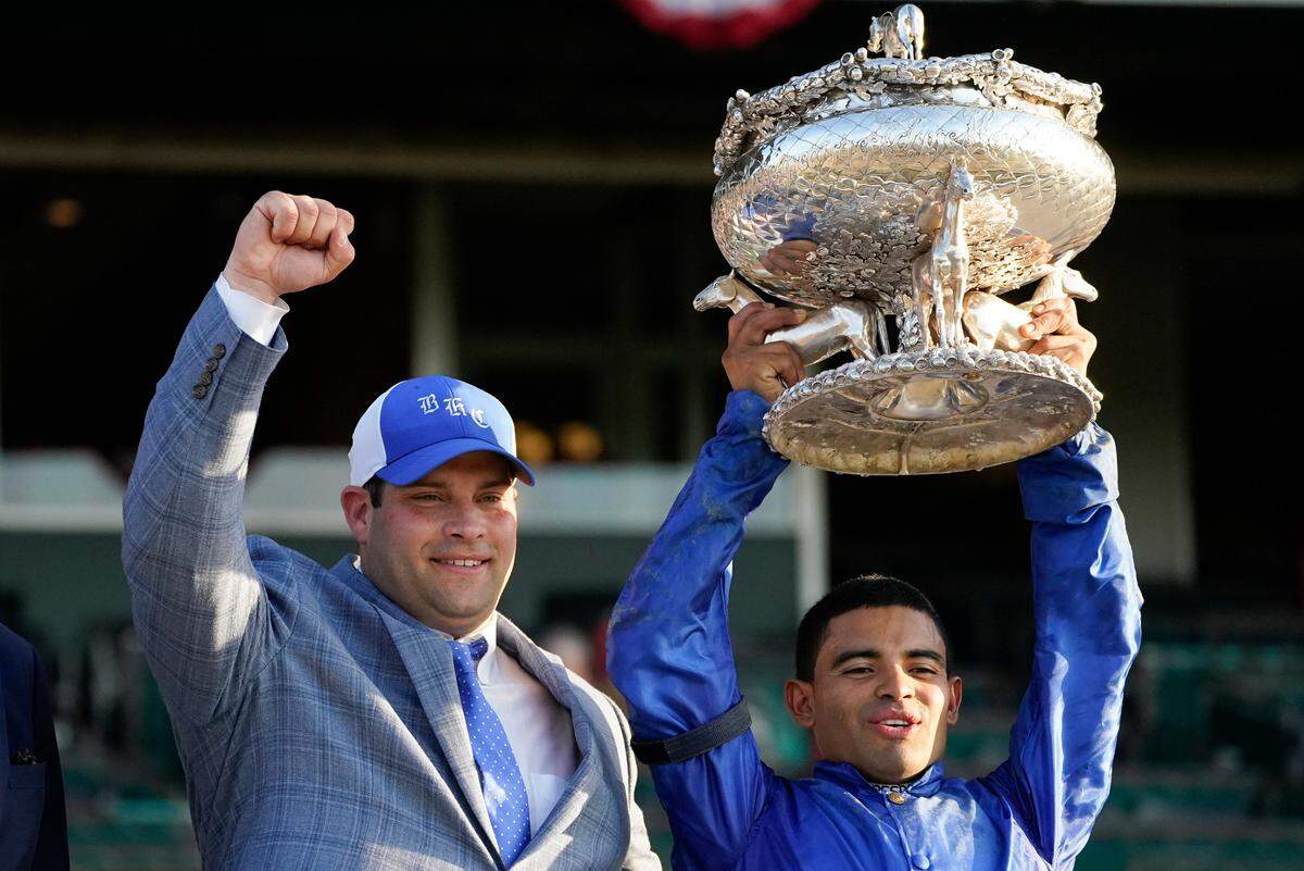 Trainer Brad Cox, left, and jockey Luis Saez celebrate Essential Quality’s victory in the 2021 Belmont Stakes.