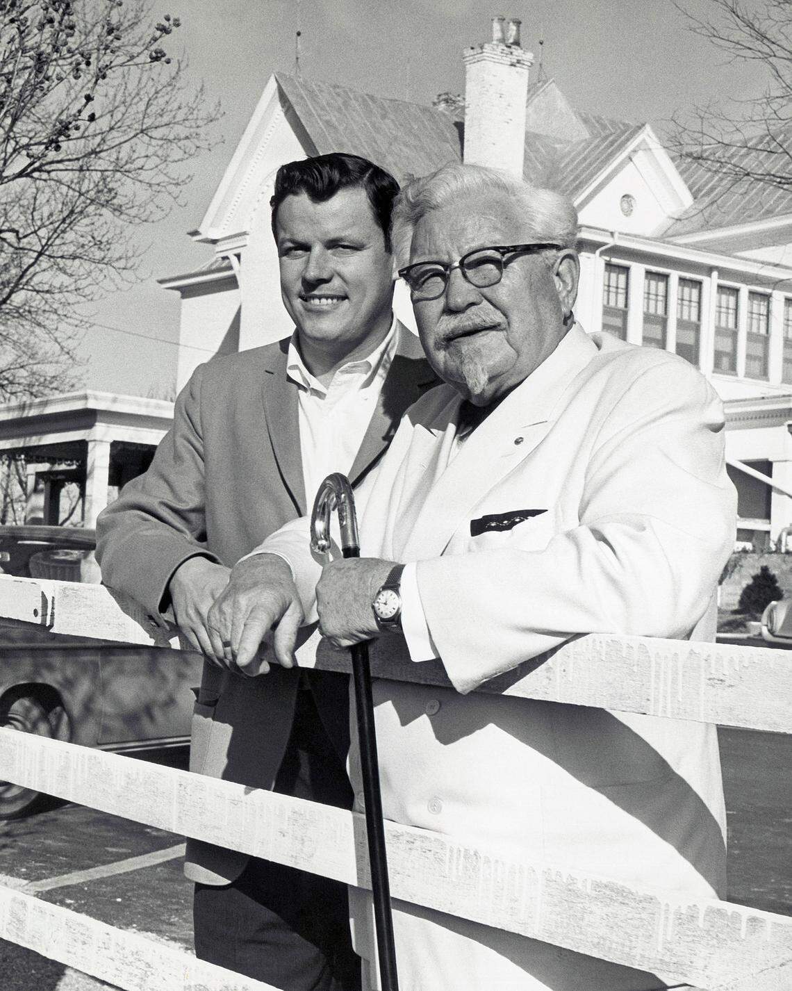 Colonel Harland Sanders, right, is selling his fried chicken process for $2 million. John Young Brown, Jr., one of the buyers is shown January 29, 1964. Sanders, now 74 and born in Henryville, Indiana, began selling franchises for his famous chicken process after he reached 65. He will stay with the new firm as a oublic relations person. (AP Photo)