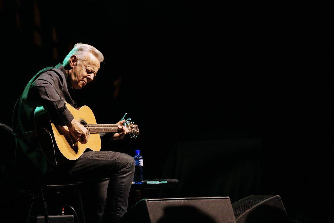 Tommy Emmanuel is known for his energetic solo performances where he plays multiple instruments.