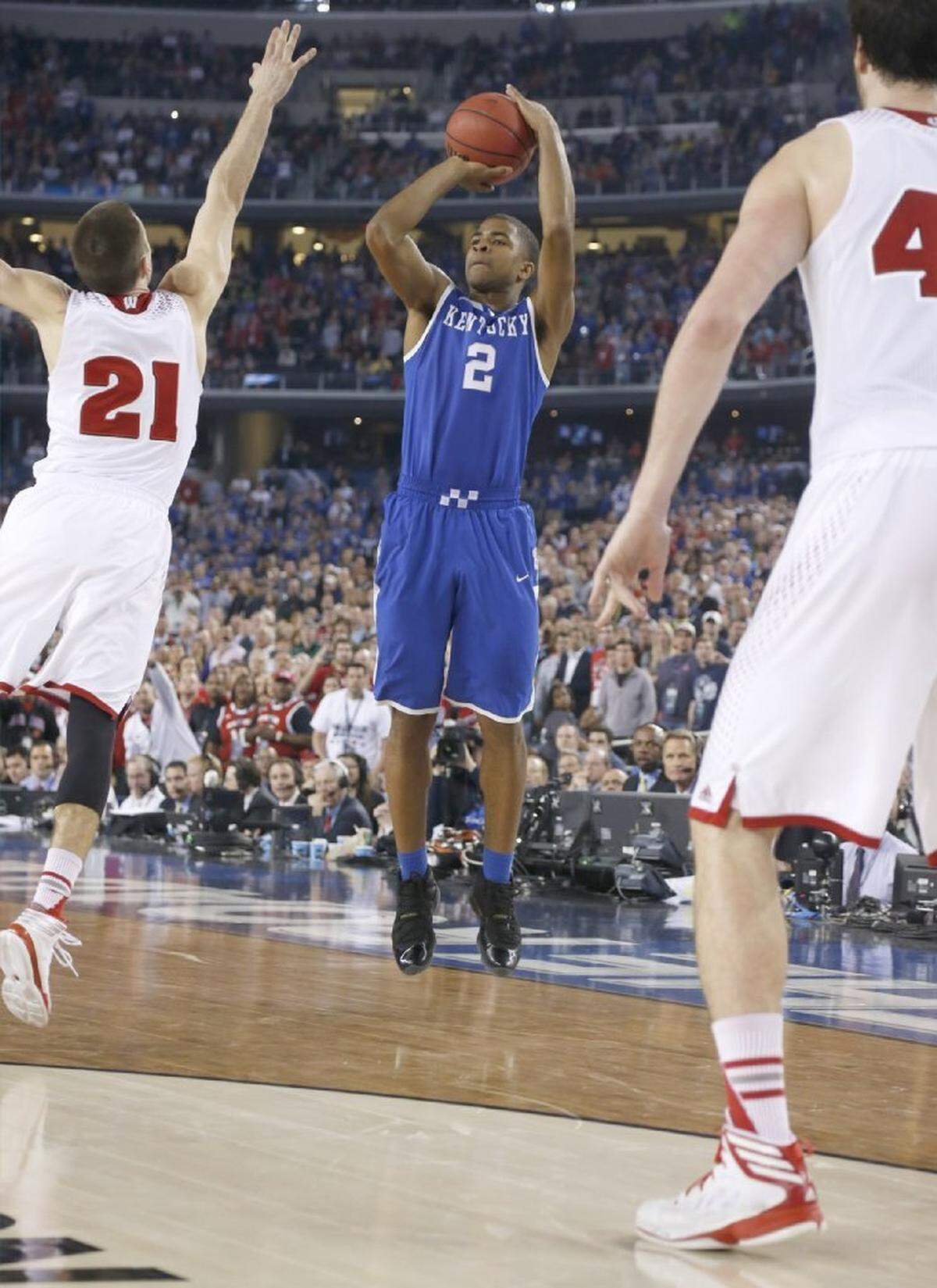 Aaron Harrison’s 3-pointer in the closing seconds lifted Kentucky to a 74-73 victory over Wisconsin in the 2014 NCAA Final Four at Arlington, Texas. It was the third straight game in which Harrison hit a shot in the final seconds to clinch victory for UK.