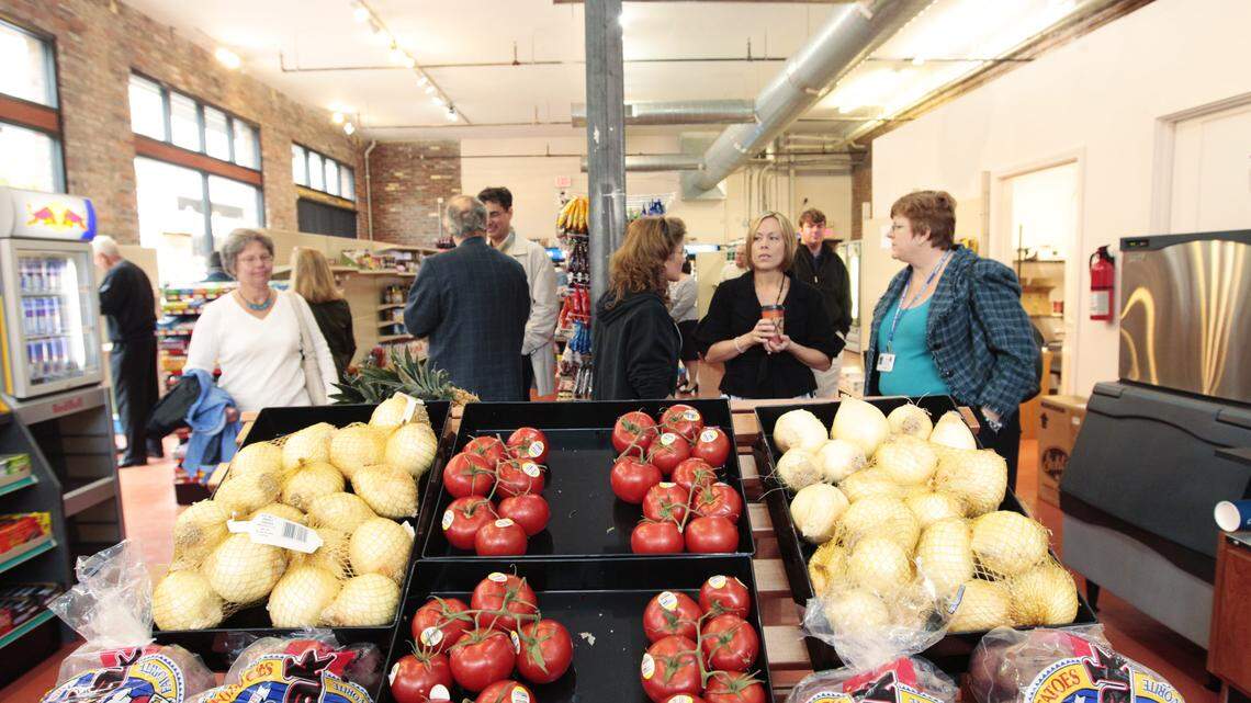 City employees and downtown residents mingled near the produce at Town Branch Market on East Main after Monday's ribbon-cutting ceremony.  