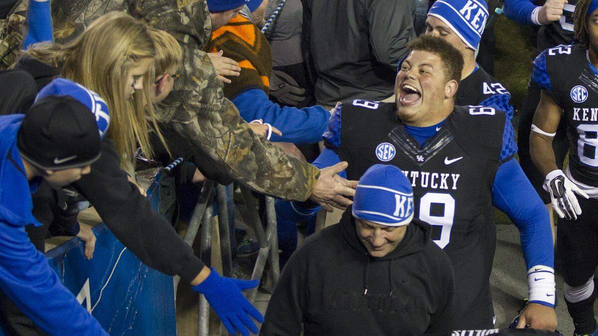 Kentucky defensive lineman Matt Elam (69) slapped fans' hands after UK defeated South Carolina Oct. 4. UK is working with the freshman to break away from poor eating habits.  