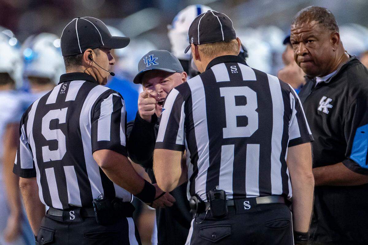 Kentucky head coach Mark Stoops speaks to the officials during Saturday’s game against Mississippi State.