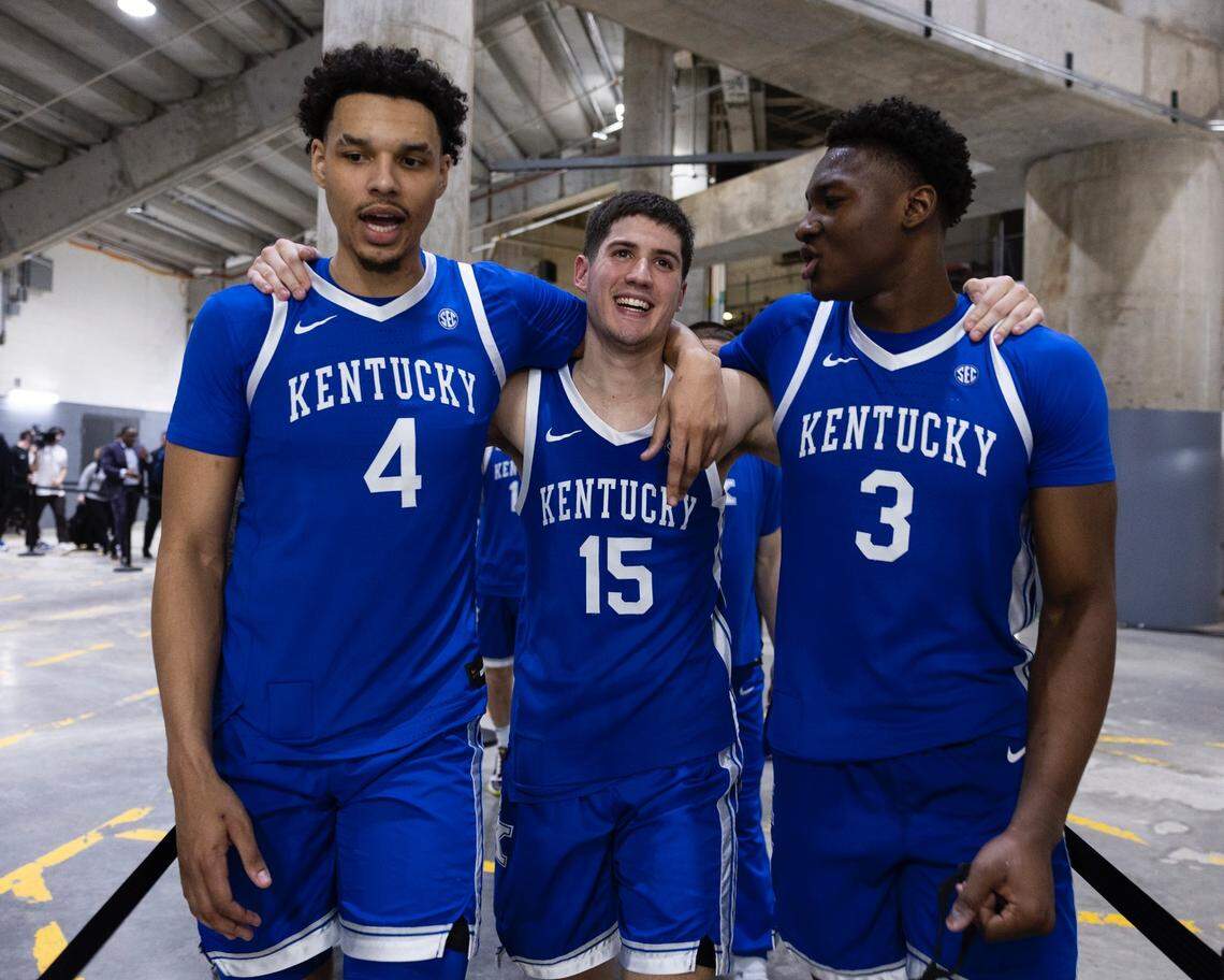 Kentucky’s Tre Mitchell, left, Reed Sheppard and Adou Thiero celebrate in the back hallways of Thompson-Boling Arena after their team’s win against Tennessee in Knoxville.