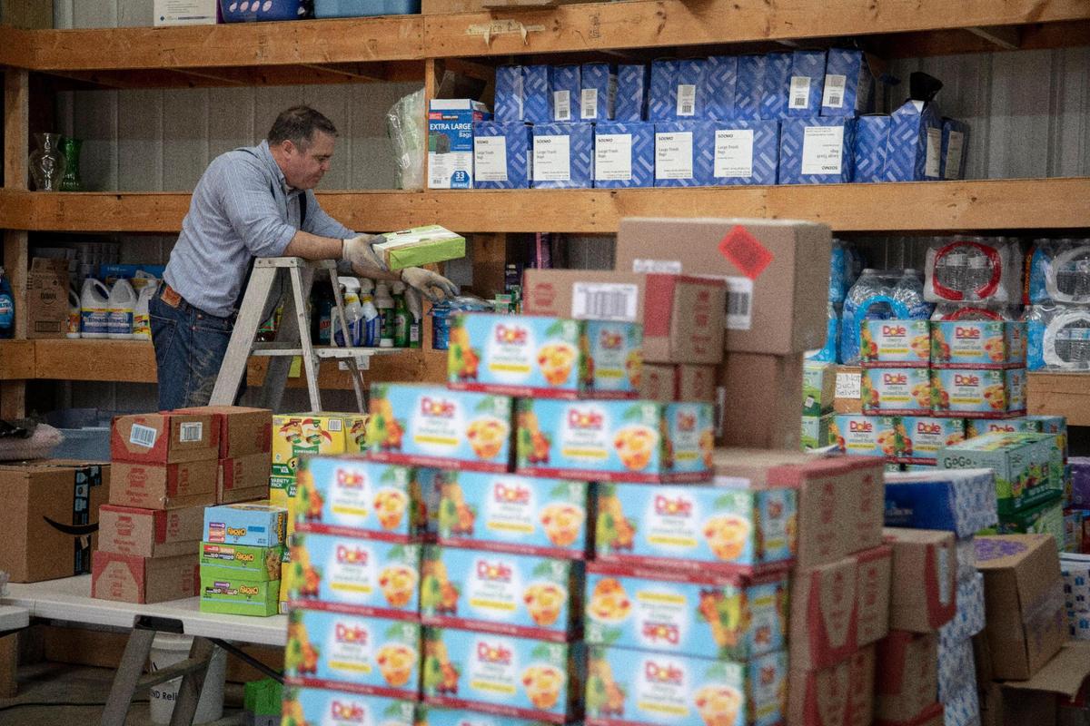 Father John Lijana works to store about $25,000 in donations of flood relief supplies at the Queen of all Saints Church in Beattyville, Ky., Thursday, March 25, 2021. The donations were gathered through social media by Papal Missionary of Mercy, Father Jim Sichko. Included in the donations were items like cleaning supplies, trash bags, food, socks, blankets, pillows and some gift cards.
