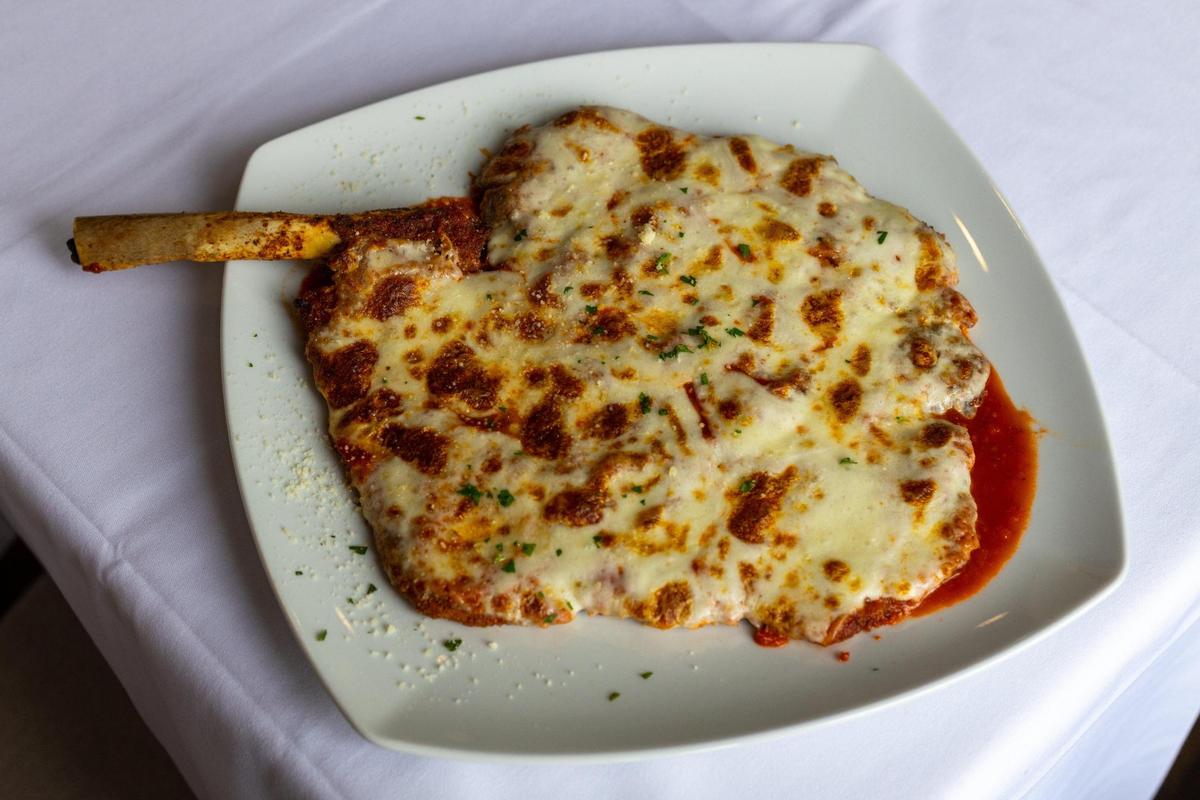 The Costoletta Parmigiana veal chop is the signature dish at Frank & Dino’s. It’s veal, pounded flat and breaded, then lightly fried and topped with pomodoro sauce. It’s listed for $48 on the menu.