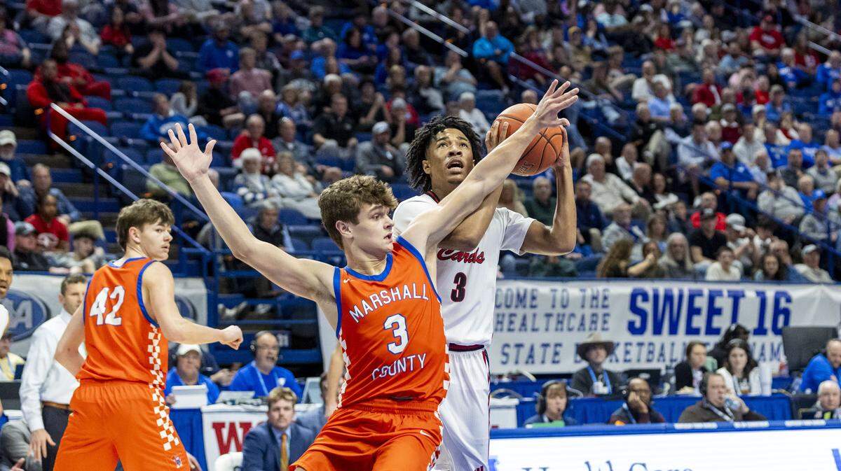 George Rogers Clark's Malachi Ashford (3) goes up for a shot past the outraced arms of Marshall County's Kaden Mohler (3) during the Cardinals 63-59 win over the Marshals in a quarterfinal round game in the 2026 UK HealthCare Boys' Basketball Sweet 16 state tournament, Friday, March 20, 2026 at Rupp Arena in Lexington, Ky.