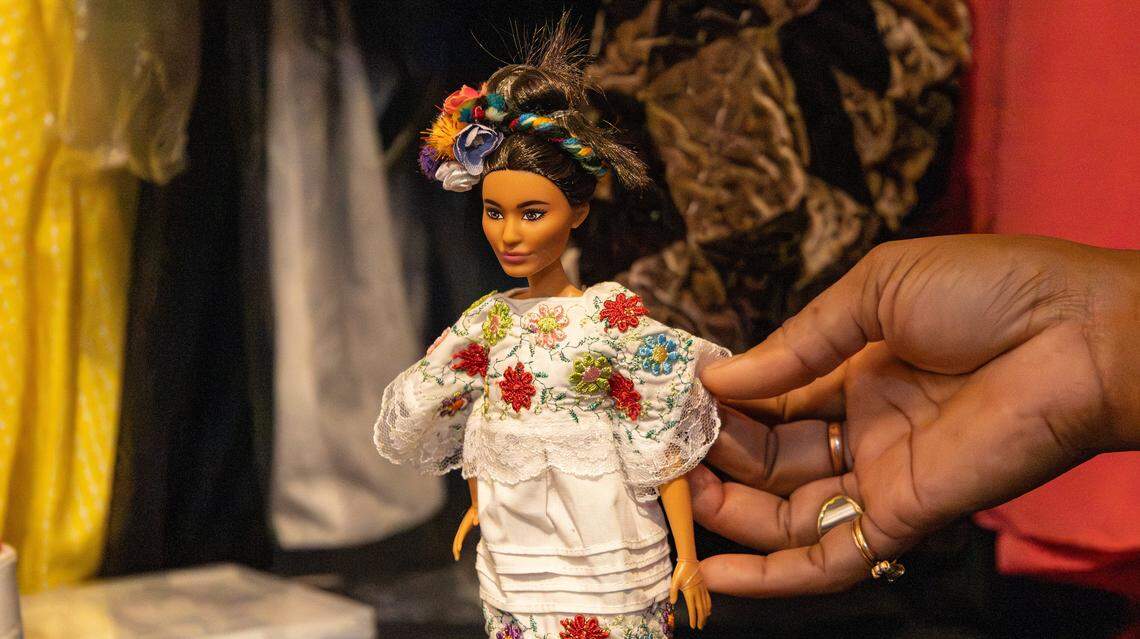 Local artist and activist fashion designer, Soreyda Benedit Begley shows the intricate details of the hand-stitched embroidery on her Mexican doll's traditional dress on Jan. 21, 2026, in Lexington, Ky.