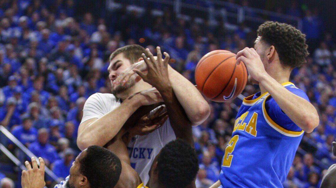 Kentucky's Isaac Humphries, top left, and Isaiah Briscoe, bottom left, scrambled for control of the ball against UCLA on Saturday afternoon in Rupp Arena.