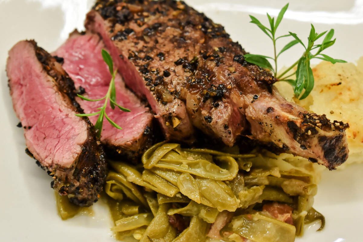 The Cowgirl Ribeye with smoked onions on the summer’s first green beans.