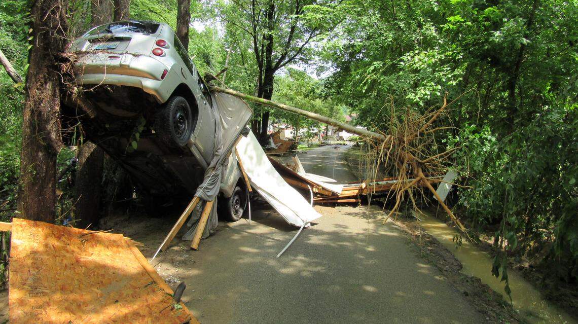 A flooded creek in Perry County, Ky., pushed a car against a tree in the Grapevine community on July 28, 2022.                      