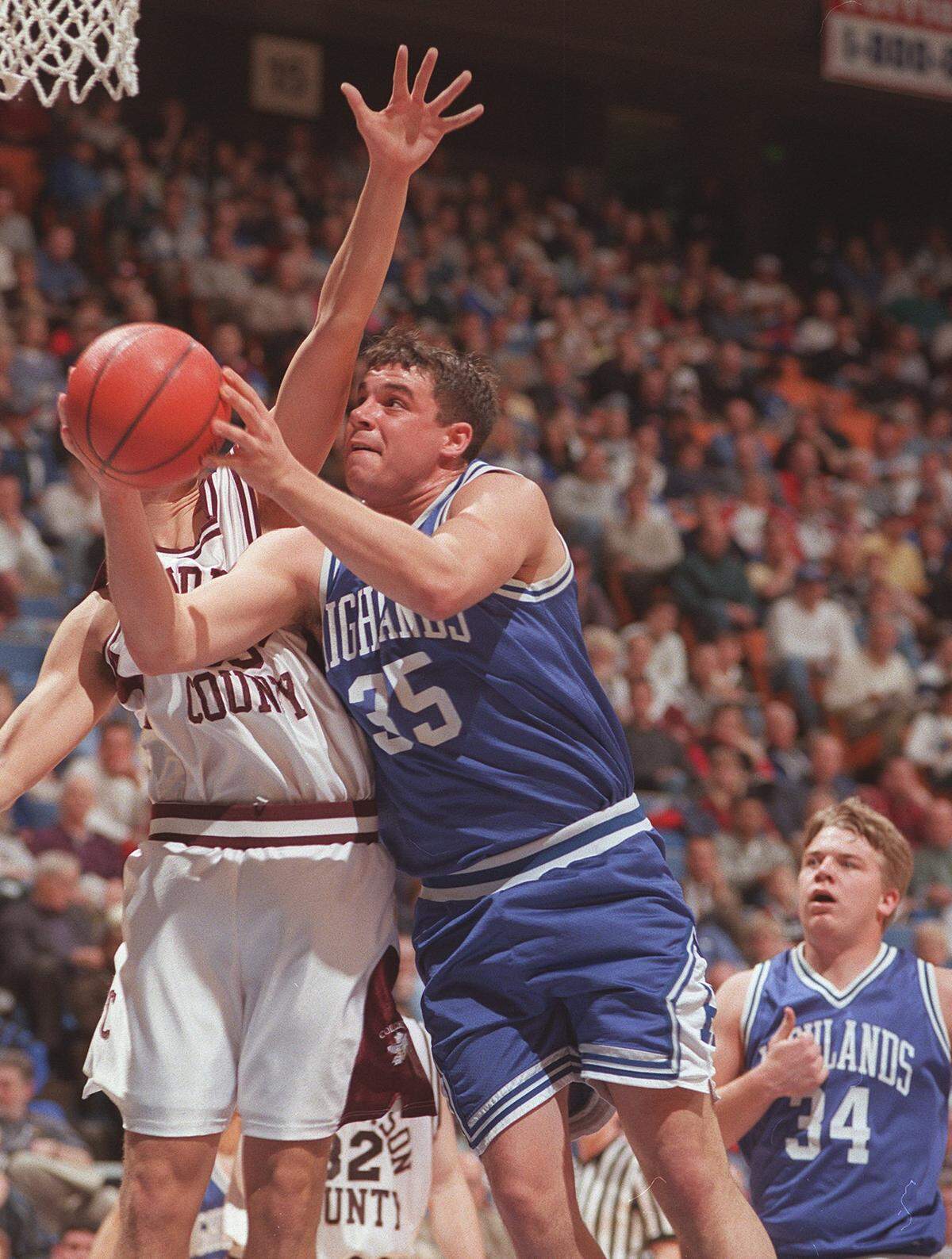 Derek Smith (35) went up for a shot while his Fort Thomas Highlands' teammate Jared Lorenzen (34)  looked on during the Bluebirds' 62-60 loss to Henderson County in the opening round of the 1999 Boys' Sweet Sixteen at Rupp Arena.