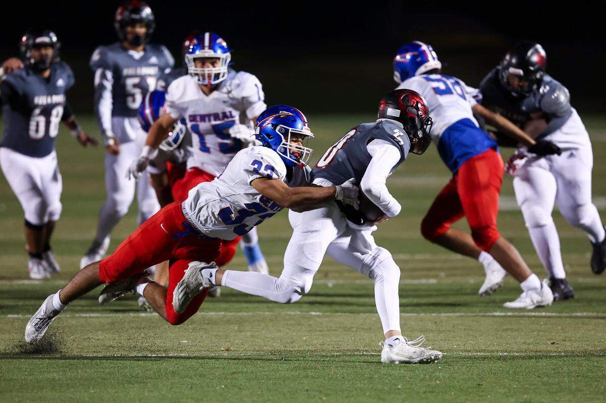 Paul Laurence Dunbar’s Kotaro Nagano is sacked by Madison Central’s Shawn Reese during Friday’s playoff game in Lexington.