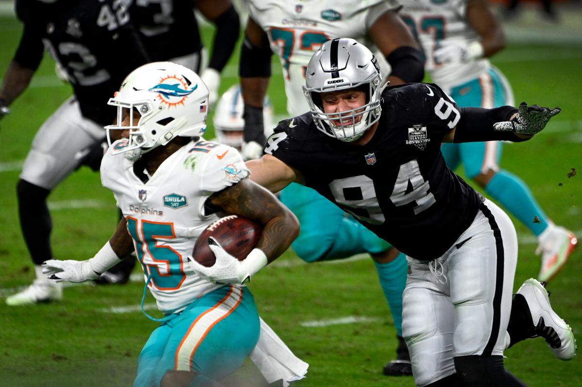 Las Vegas Raiders defensive end Carl Nassib (94) reached to tackle Miami Dolphins wide receiver Lynn Bowden (15) during an NFL football game on Dec. 26, 2020.