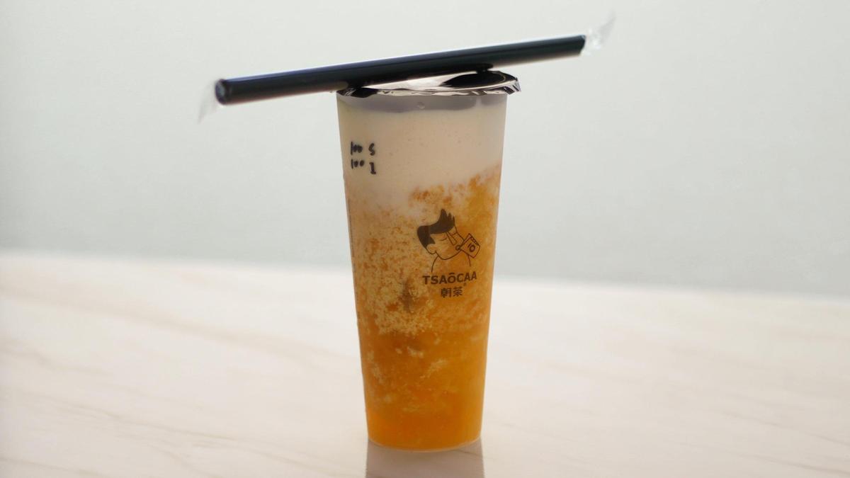 Iced mango green tea with milk foam offered at TSAOCHA bubble tea shop on South Broadway.