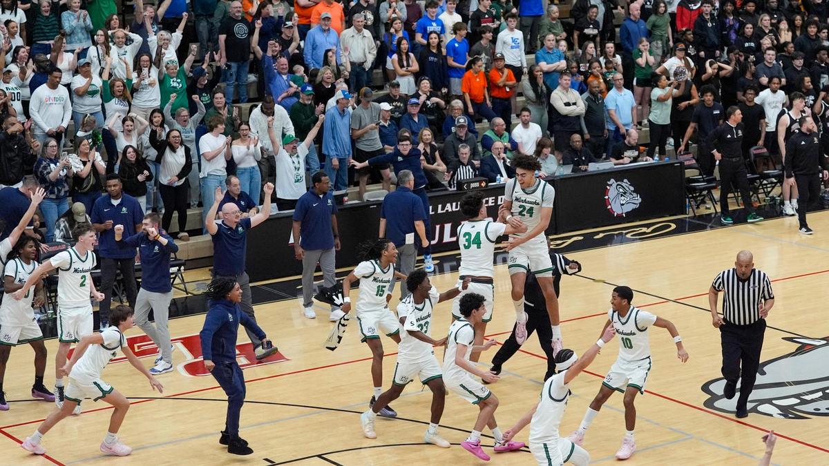 Great Crossing’s Brady Orem (34), Malachi Moreno (24) and their teammates celebrate after the final horn of their 59-57 win over Frederick Douglass in the 11th Region Tournament championship game at Paul Laurence Dunbar’s S.T. Roach Sports Center on Tuesday.