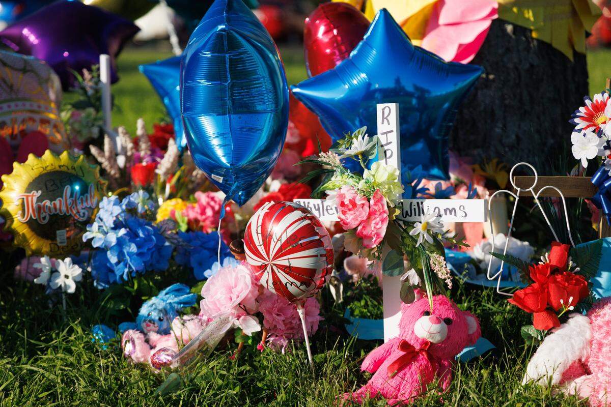 Members of the community and FaithPointe Church created a memorial during a vigil on Monday, May 9, 2022, at Parkway Plaza Apartments in Lexington, Kentucky, for Skyler Williams, 5, and Deon Williams, 13, who were killed last week. Their mother has been accused of killing the two children.