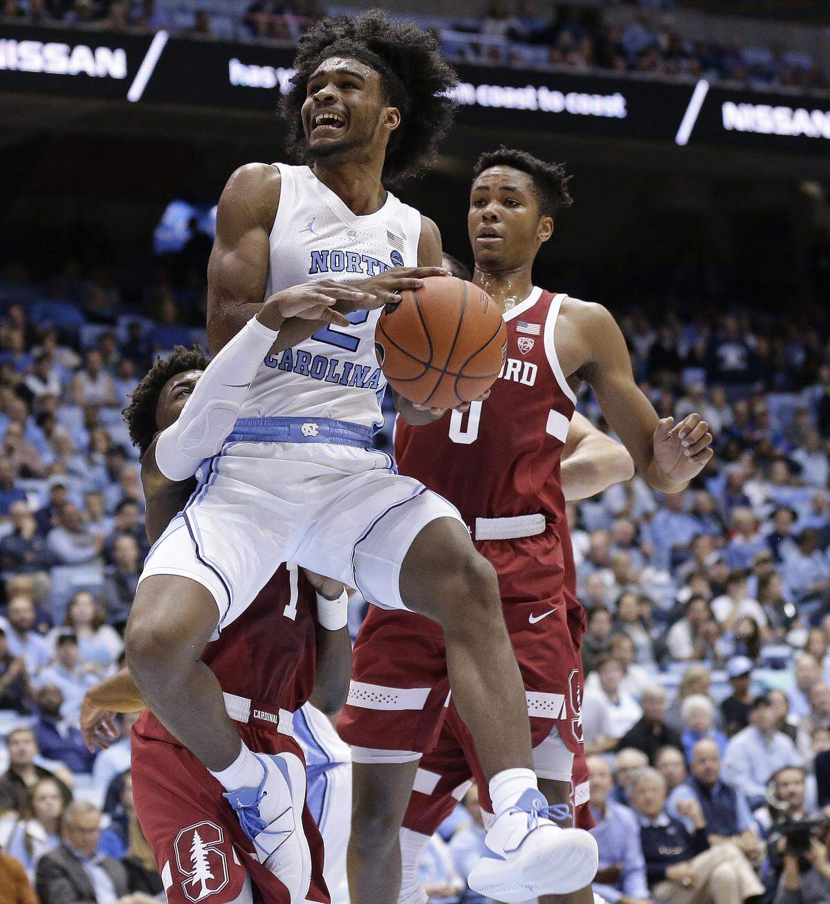 North Carolina’s Coby White (2) tried to get to the basket against Stanford’s Daejon Davis, left, and KZ Okpala on Nov. 12.