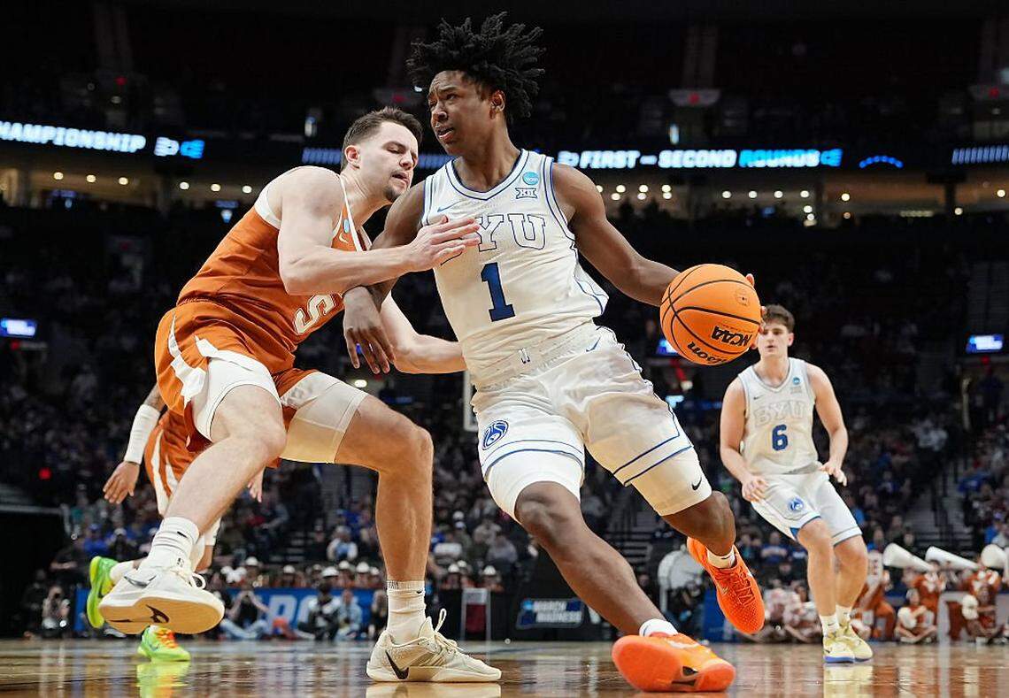 PORTLAND, OREGON - MARCH 19: Robert Wright III #1 of the BYU Cougars dribbles the ball while being guarded by Camden Heide #5 of the Texas Longhorns during the second half in the first round of the 2026 NCAA Men's Basketball Tournament at Moda Center on March 19, 2026 in Portland, Oregon. (Photo by Soobum Im/Getty Images)
