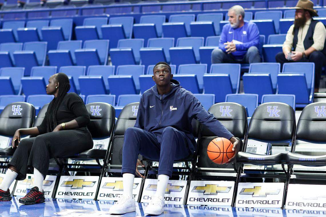 Kentucky men’s basketball recruit Khaman Maluach sits on a bench at Rupp Arena while on an official visit to UK in Lexington on Tuesday, February 13, 2024.