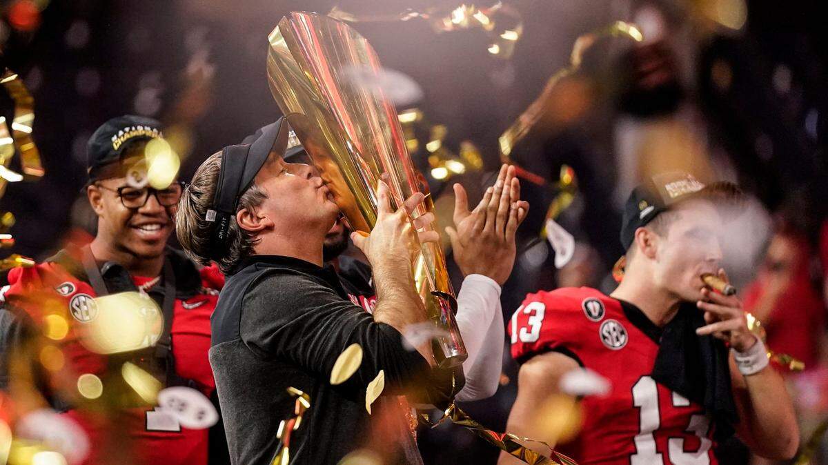 Georgia head coach Kirby Smart kisses the championship trophy after the College Football Playoff title game against TCU on Monday night. Georgia won 65-7.