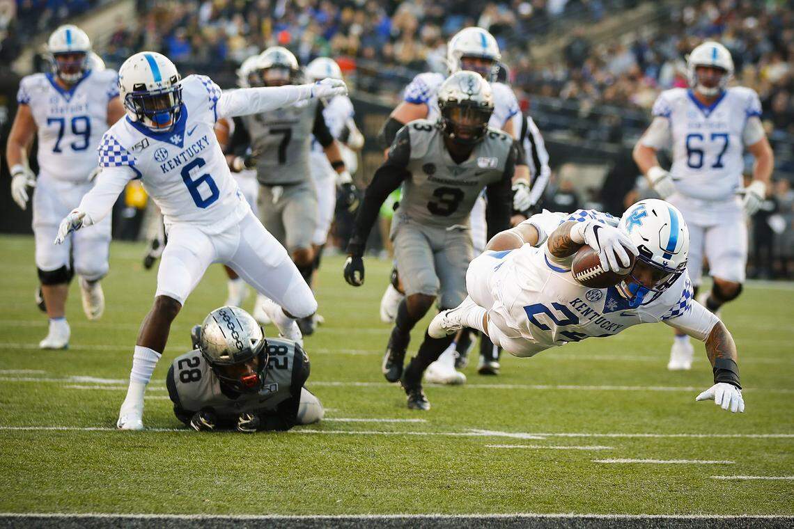 Kentucky Wildcats running back Christopher Rodriguez Jr. (24) dives into the end zone for a touchdown past Vanderbilt Commodores defenders during their game at Vanderbilt Stadium in Nashville, Tenn., Saturday, Nov. 16, 2019.