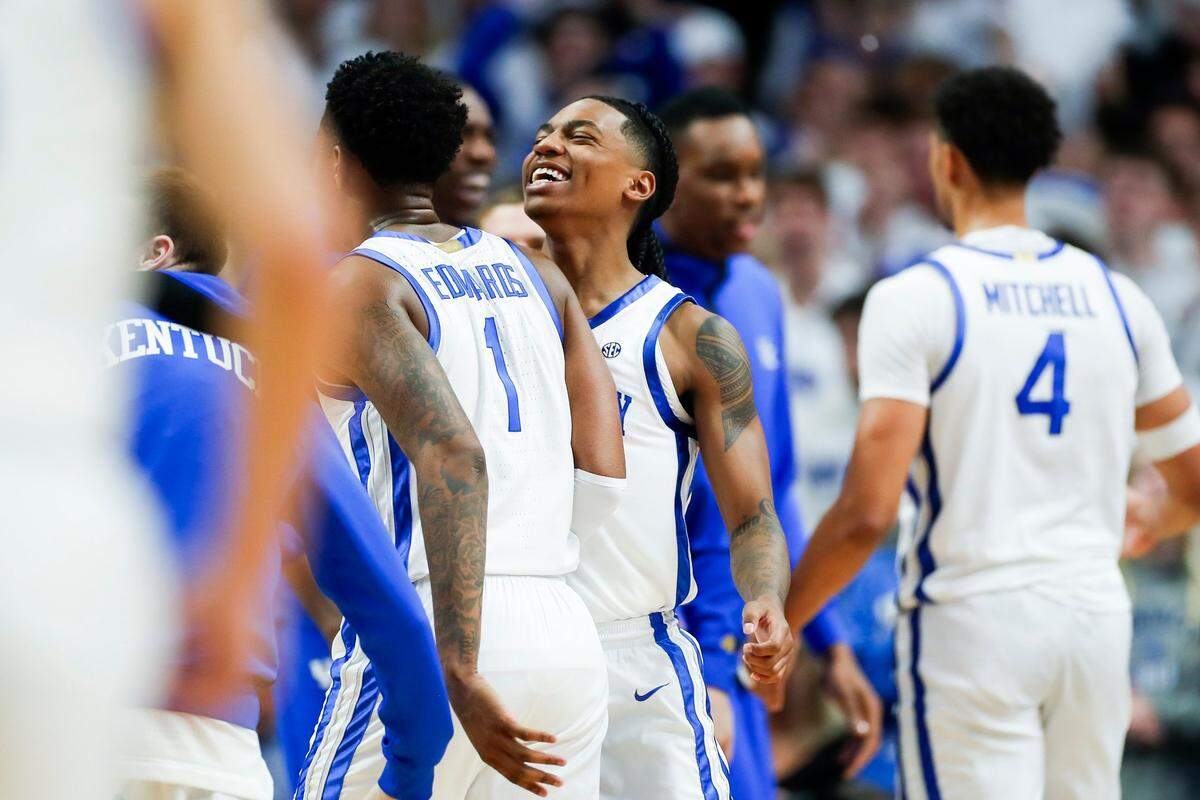 Kentucky guard Rob Dillingham, center, celebrates with guard Justin Edwards (1) after the Wildcats took the lead against Miami at halftime.