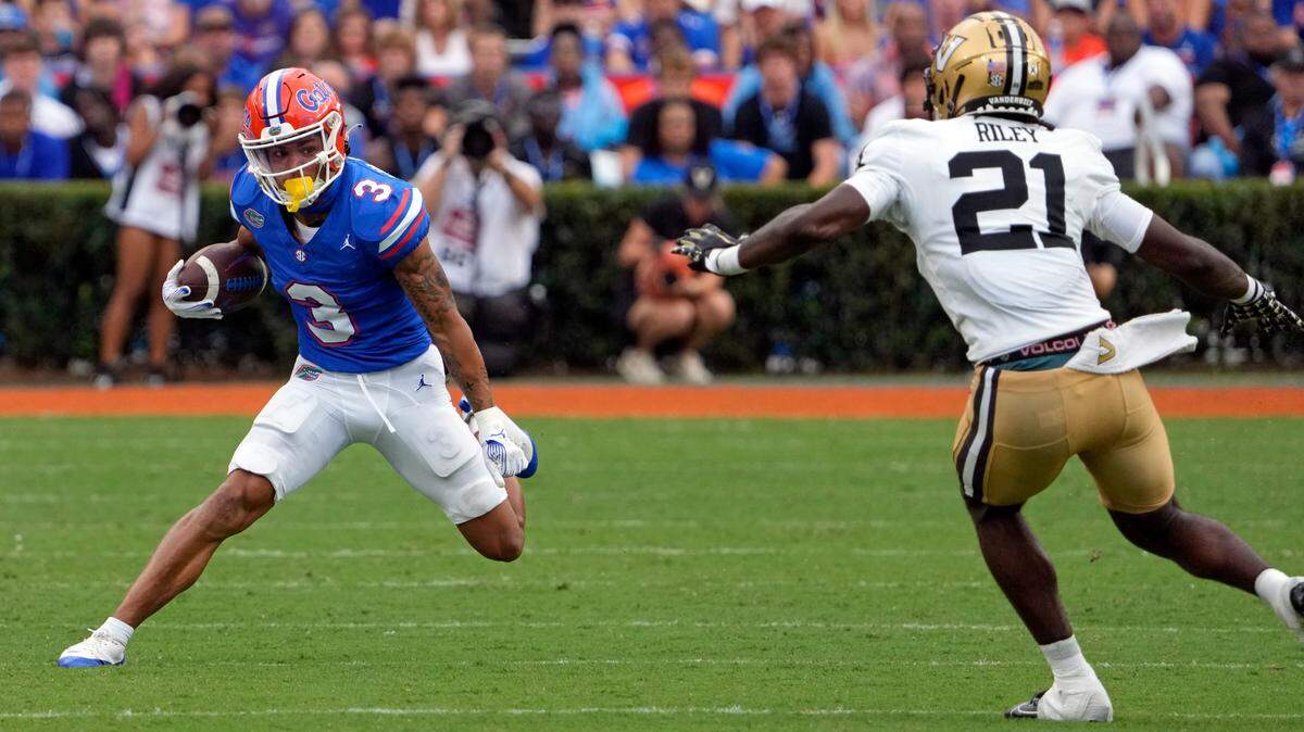 Florida wide receiver Eugene Wilson III (3) looks for a way around Vanderbilt safety Savion Riley (21) after a reception during the first half of an NCAA college football game, Saturday, Oct. 7, 2023, in Gainesville, Fla. (AP Photo/John Raoux)