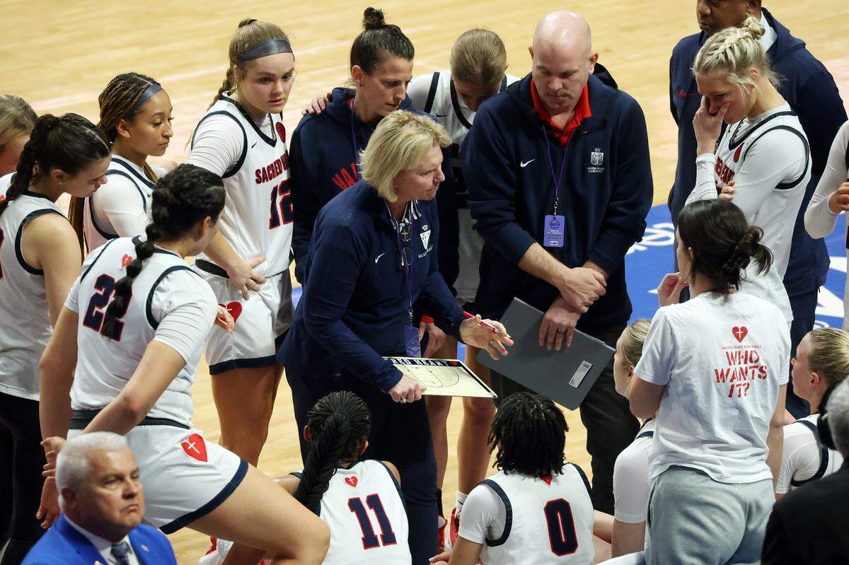 Sacred Heart head coach Donna Moir instructs her team during a break in the action Friday night. The Valkyries are seeking their unprecedented fourth consecutive state championship.