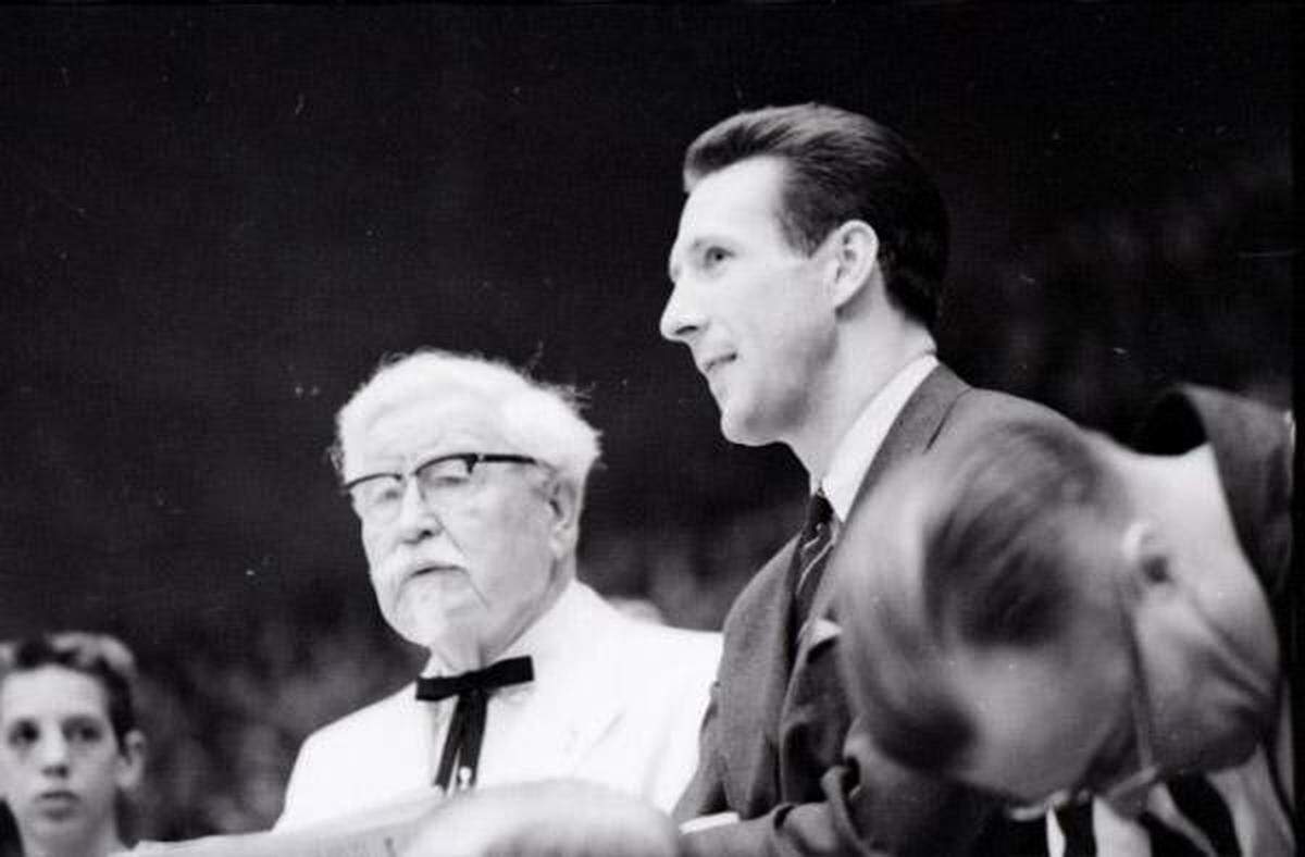 Harland Sanders, left, founder of Kentucky Fried Chicken, and Adrian Smith, a member of UK's Fiddlin’ Five that won the 1958 NCAA men’s basketball national championship, attended the Kentucky-Vanderbilt basketball game Jan. 15, 1966 at Memorial Coliseum in Lexington.