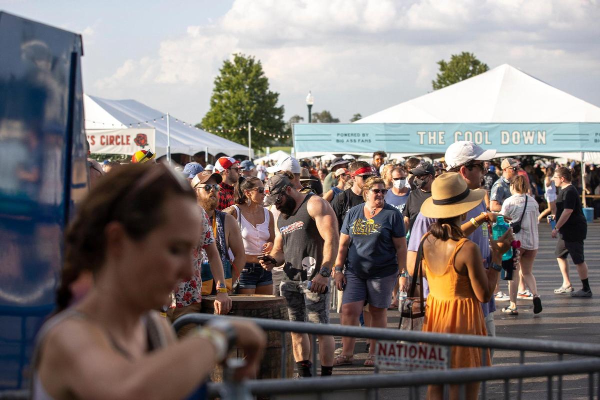 People wait in line to get water at a water refill station at the Railbird Festival at Keeneland in Lexington, Ky., on Saturday, Aug. 28, 2021.
