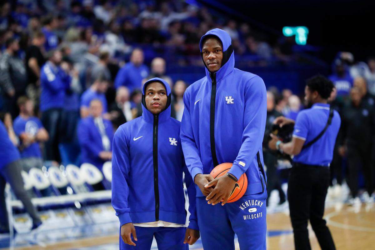 Sahvir Wheeler, left, and Oscar Tshiebwe, right, took the floor before Thursday night’s exhibition game in Rupp Arena but did not warm up with the team or play. Both are battling injuries suffered this preseason.