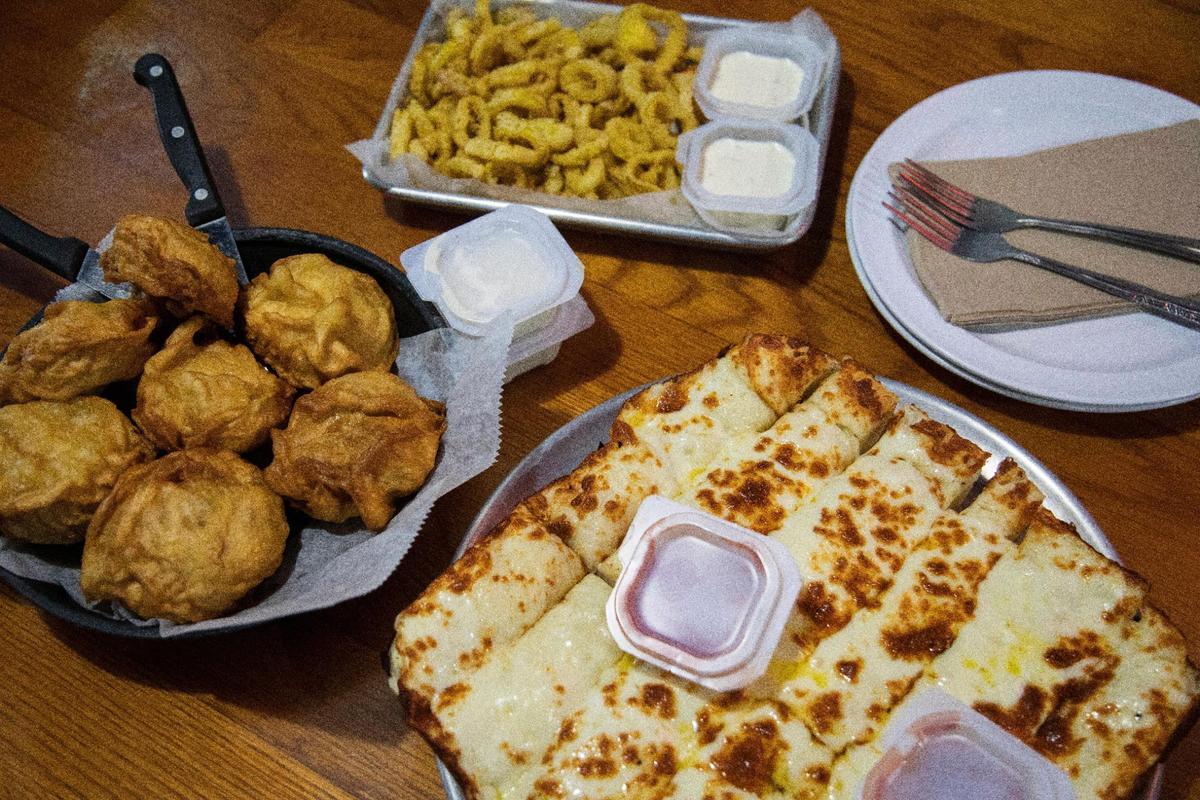 Stuffed deep dish pizza is not the only thing on the menu at Stellian’s Pizzeria in Central City, Ky. Clockwise from the bottom: Bread sticks, batter fried mushrooms and fried pepperoncicis.