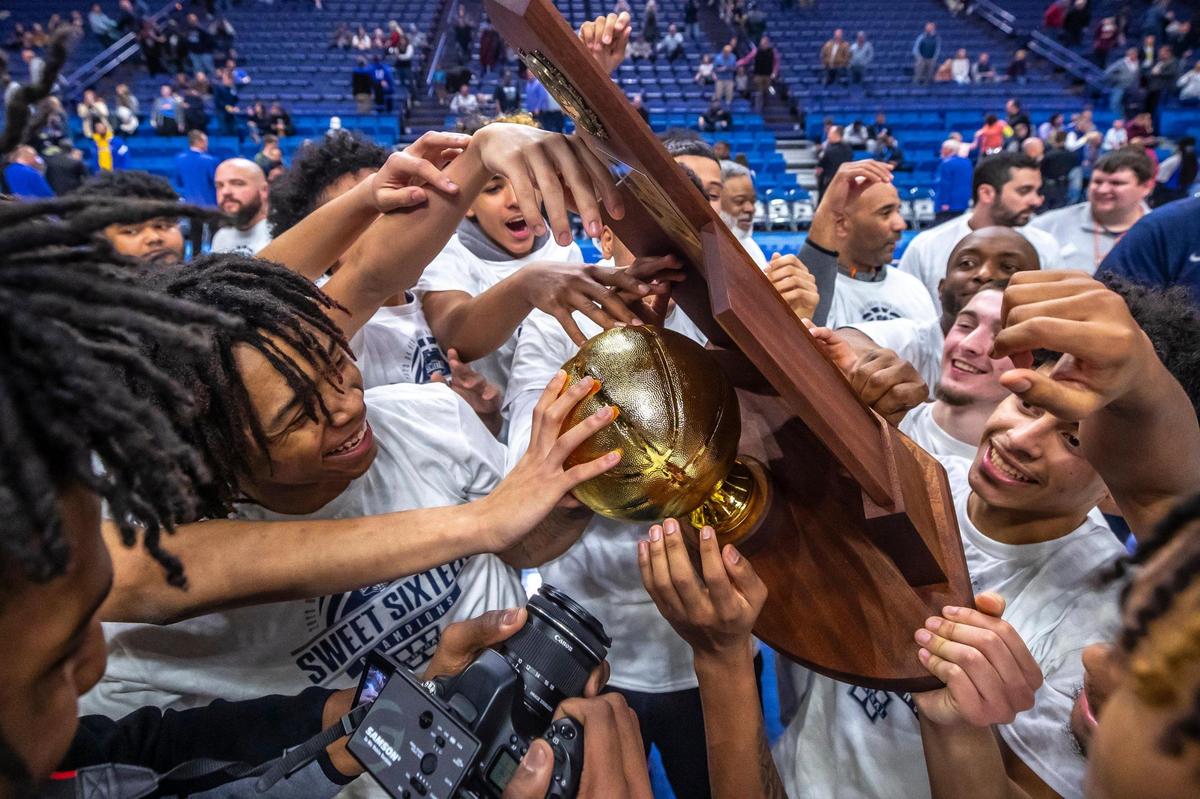 Warren Central celebrates with the state championship trophy after defeating George Rogers Clark in Rupp Arena on Saturday night. Last year, George Rogers Clark won the title game over Warren Central.