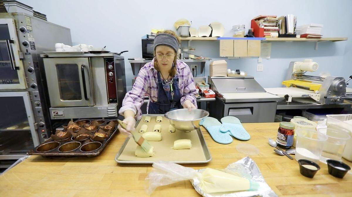 Bakery assistant Alexandria Gurnee works on chocolate croissants at Spoonful of Sugar, Sweets and Such in Mt. Sterling. “When you cut through a croissant, you should see individual layers. It should look like a loaf of bread,” owner Danielle King said.