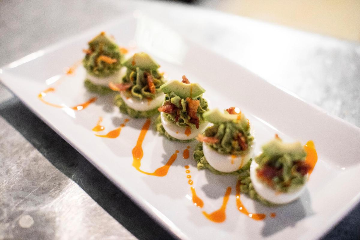 The Deviled Green Goddess Eggs in the Wrigley Taproom in Corbin, Ky., Wednesday, June 16, 2021. The deviled eggs have tarragon, parsley, sliced avocado, jowl lardons and paprika oil.
