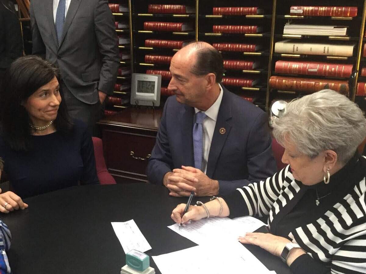 House Minority Floor Leader Rocky Adkins smiles at his running mate, Stephanie Horne, as state administration and elections director Mary Sue Helm reviews their filing papers Thursday, Jan. 24, 2019, to run for governor and lieutenant governor.