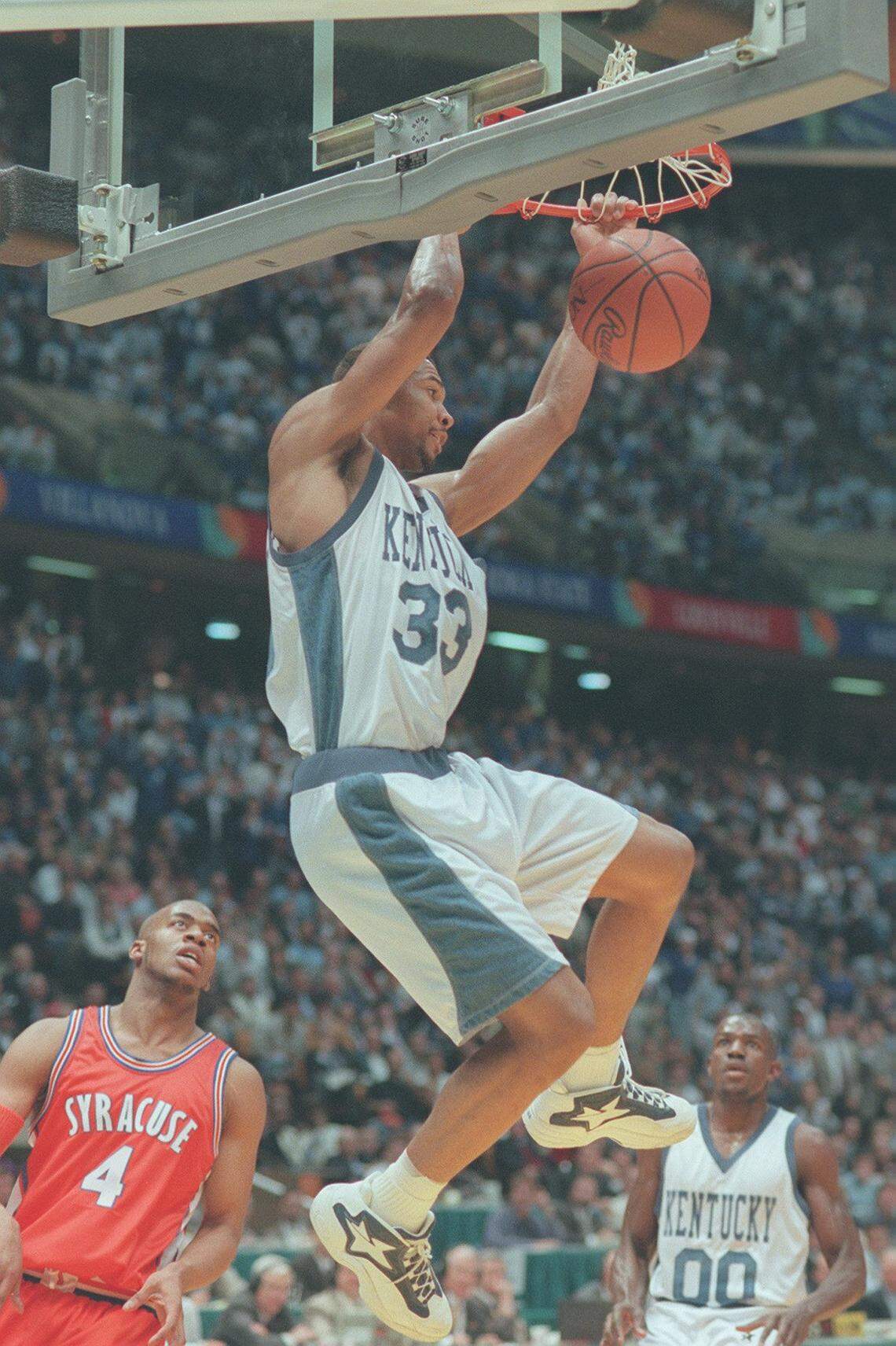 UK basketball player Ron Mercer dunks the ball during the NCAA Tournament championship game against Syracuse on April 1, 1996, in East Rutherford, New Jersey. Kentucky won the 1996 NCAA championship while wearing distinct denim-themed uniforms. 