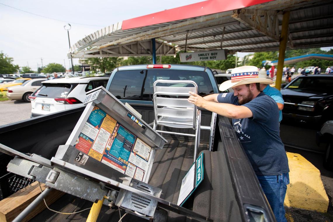 Dakota Means loads his purchases from Parkette Drive-In’s sale in Lexington, Ky., Saturday, July 23, 2022.