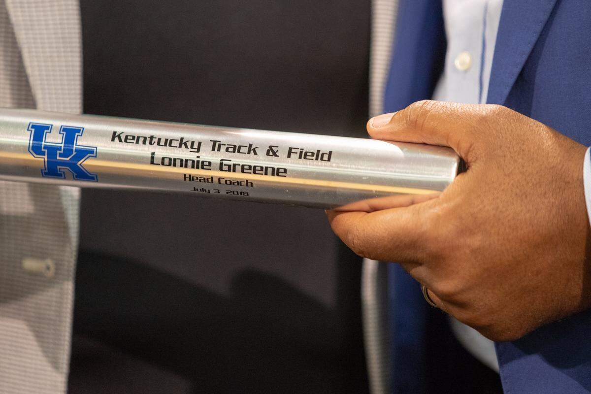 New UK track and field coach Lonnie Greene received a baton with his name on it during his introductory news conference at Kroger Field last week.