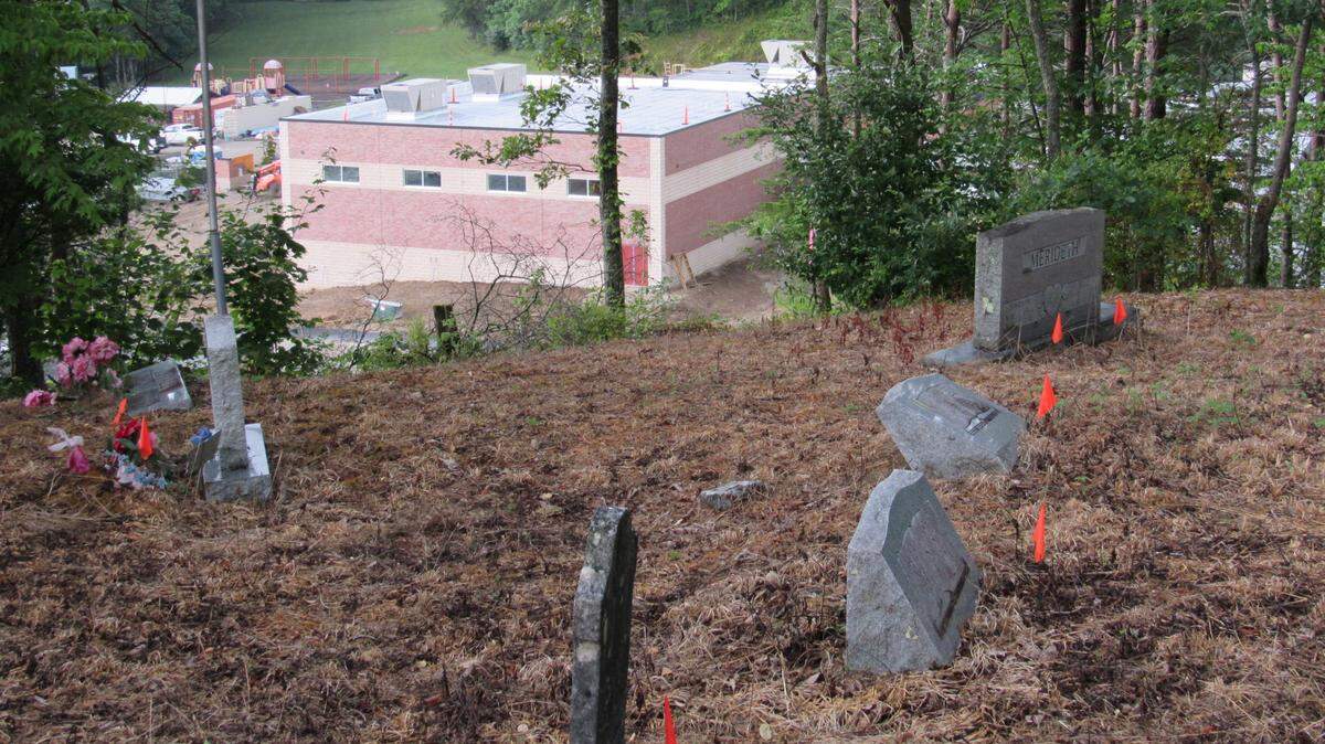 The Hoskins Cemetery is on top of a steep hill overlooking Manchester Elementary School, as shown in a July 8, 2021 photo. The Clay County Board of Education wants to move the graves.