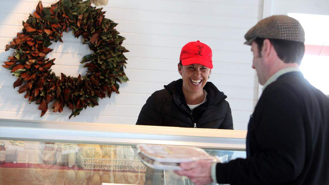 Customer Melissa Bipp of Danville talked with McAlister while he worked the meat counter at the store last week.