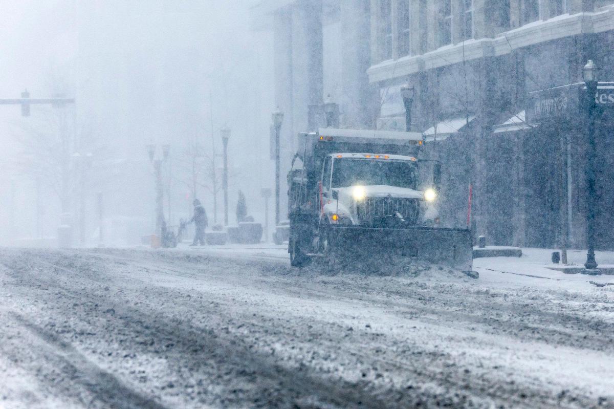 A snowplow drives along Main Street in downtown Lexington, Ky., on Sunday, Jan. 5, 2025.