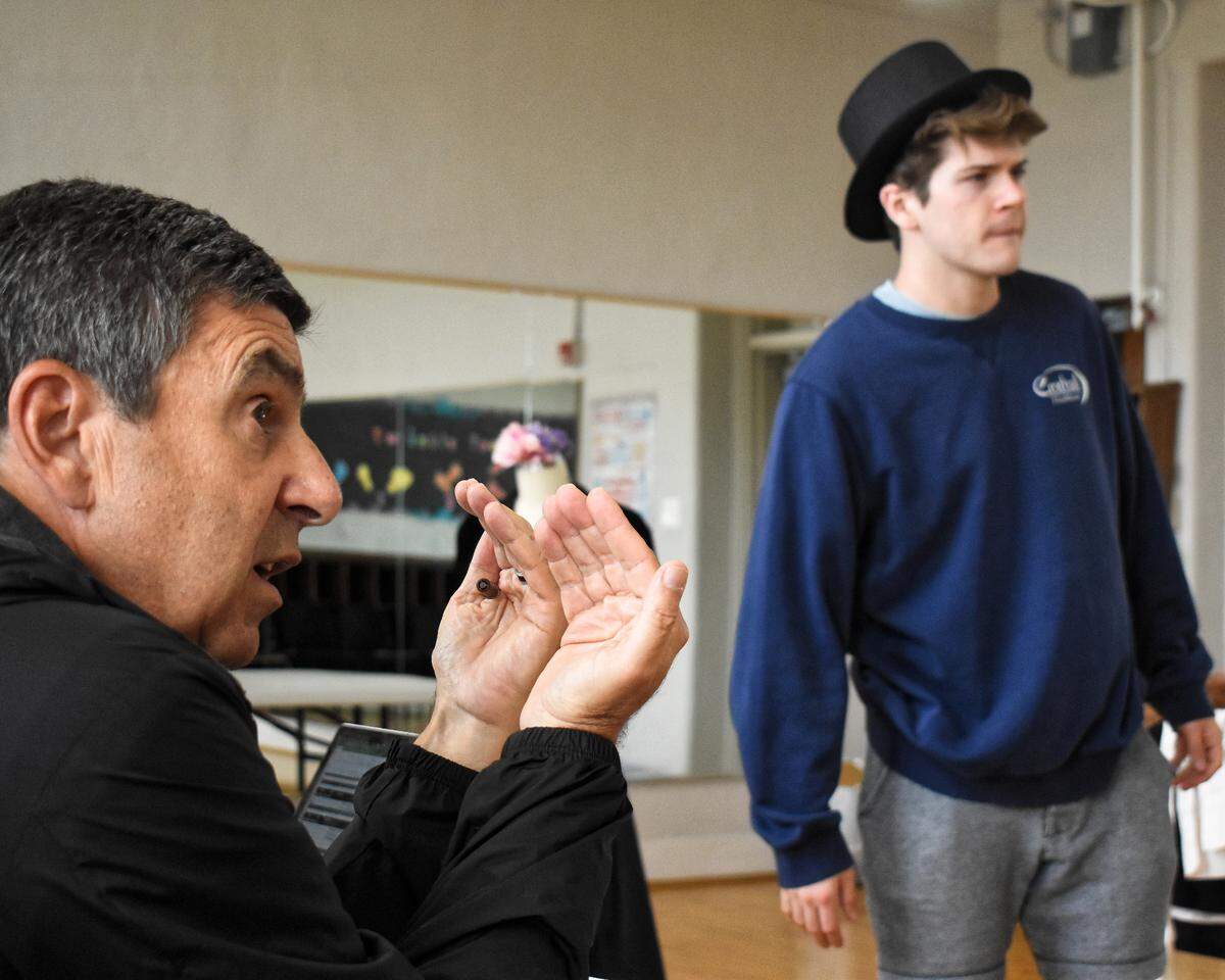 Director Mark Madama (left) gives notes to actors, including Lexington native Colton Ryan as Tony, in a rehearsal of “West Side Story.”