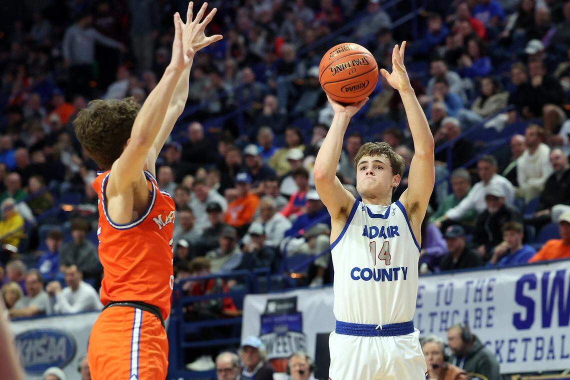 Connor Loy (14) got off a shot over Marshall County’s Kaden Mohler on Wednesday night. Loy scored 11 points and led Adair County with eight assists while committing no turnovers.