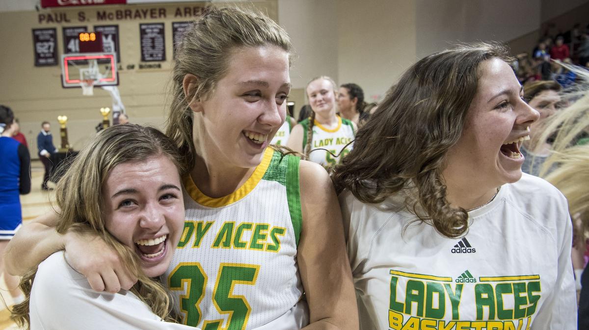 Owensboro Catholic’s Catherine Head, left, celebrates with teammates Ally Maggard, center, and Allie Hamilton, right, after beating Walton Verona 44-40, during the finals of the girls All-A Classic, Sunday, January 27, 2019, at EKU’s McBrayer Arena in Richmond.