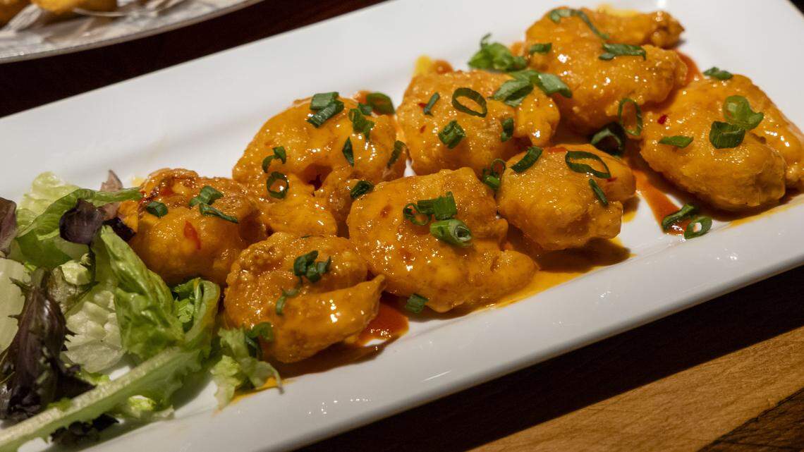 The Famous Firestone Shrimp appetizer ($14.50) at Ford’s Garage, photographed Tuesday, Nov. 4, 2025 in Lexington, Ky. The lightly battered crispy shrimp are tossed in spicy “boom boom” sauce and topped with green onions.