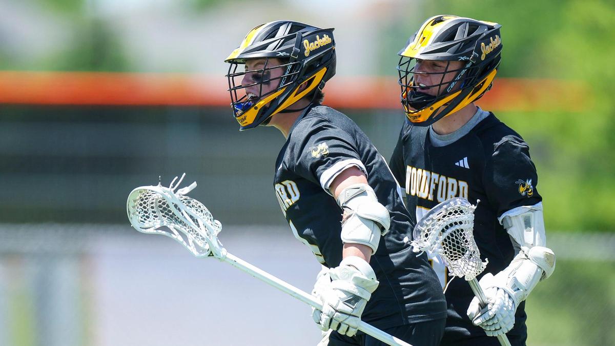 Woodford County’s Behr Wheeler (4), left, and Woodford County’s Aidan McMahon (3) celebrate after Wheeler scored a goal during the Yellowjacket’s 16-6 win over Frederick Douglass in the 2025 KHSAA Boys’ Lacrosse State Tournament quarterfinals, Saturday.